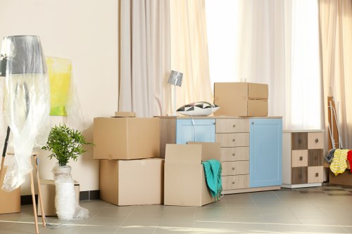 Piano movers protecting floors and doorways during a Surrey relocation
