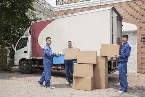 House movers working on a Surrey residential street with moving van and boxes