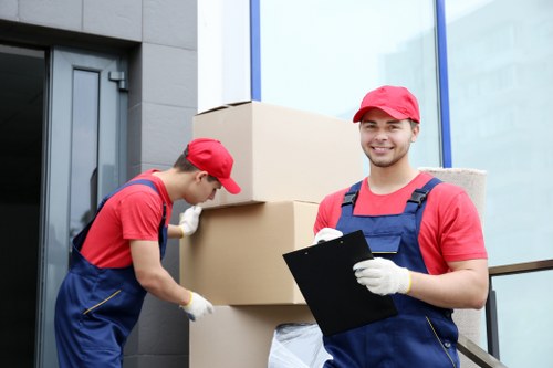 Man and van loading household items into a moving vehicle