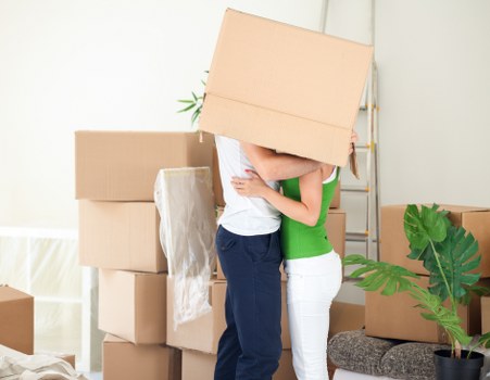 Packed moving boxes and furniture prepared for house removals in Surrey